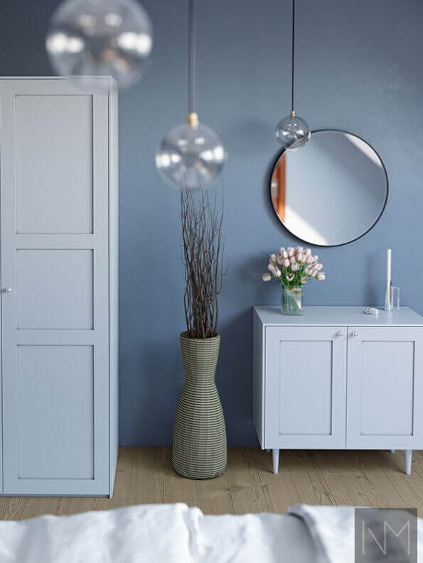 light blue bedroom with circle mirror
