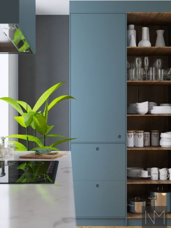 fake plant placed on kitchen surface infront kitchen appliances