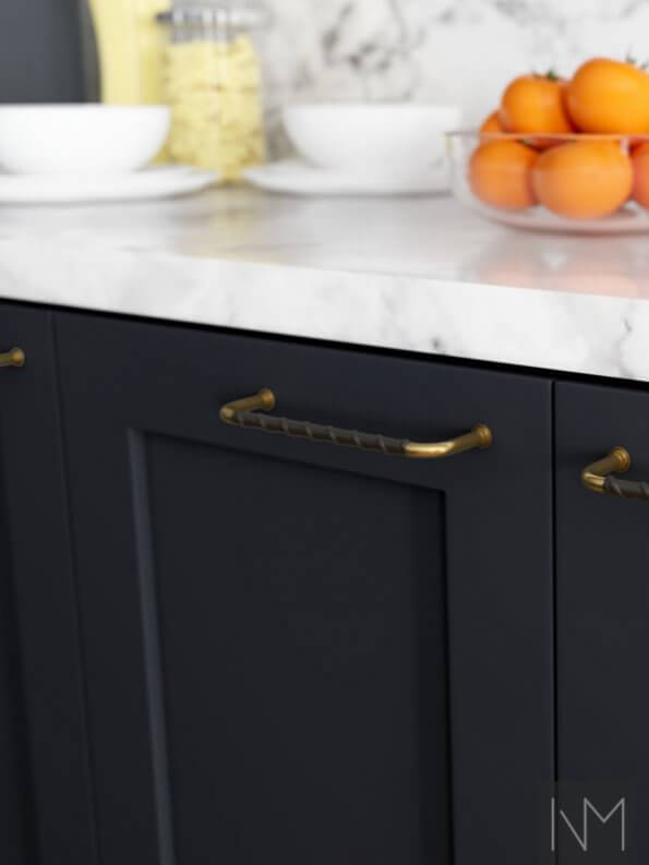 golden handles on navy cabinets
